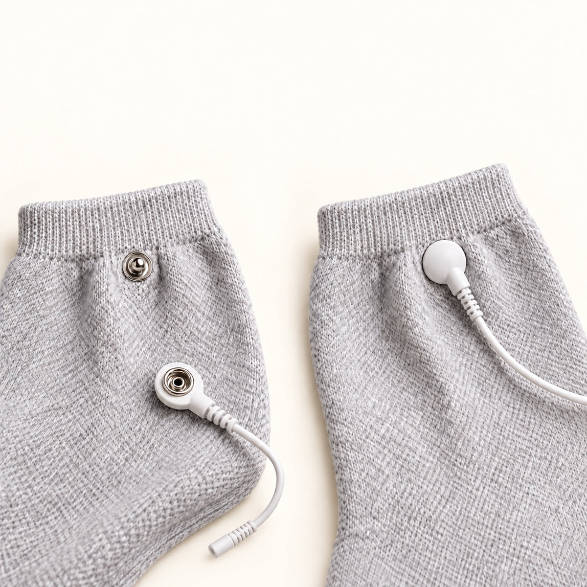 Two sock cuffs showing detached and attached cable connectors side by side