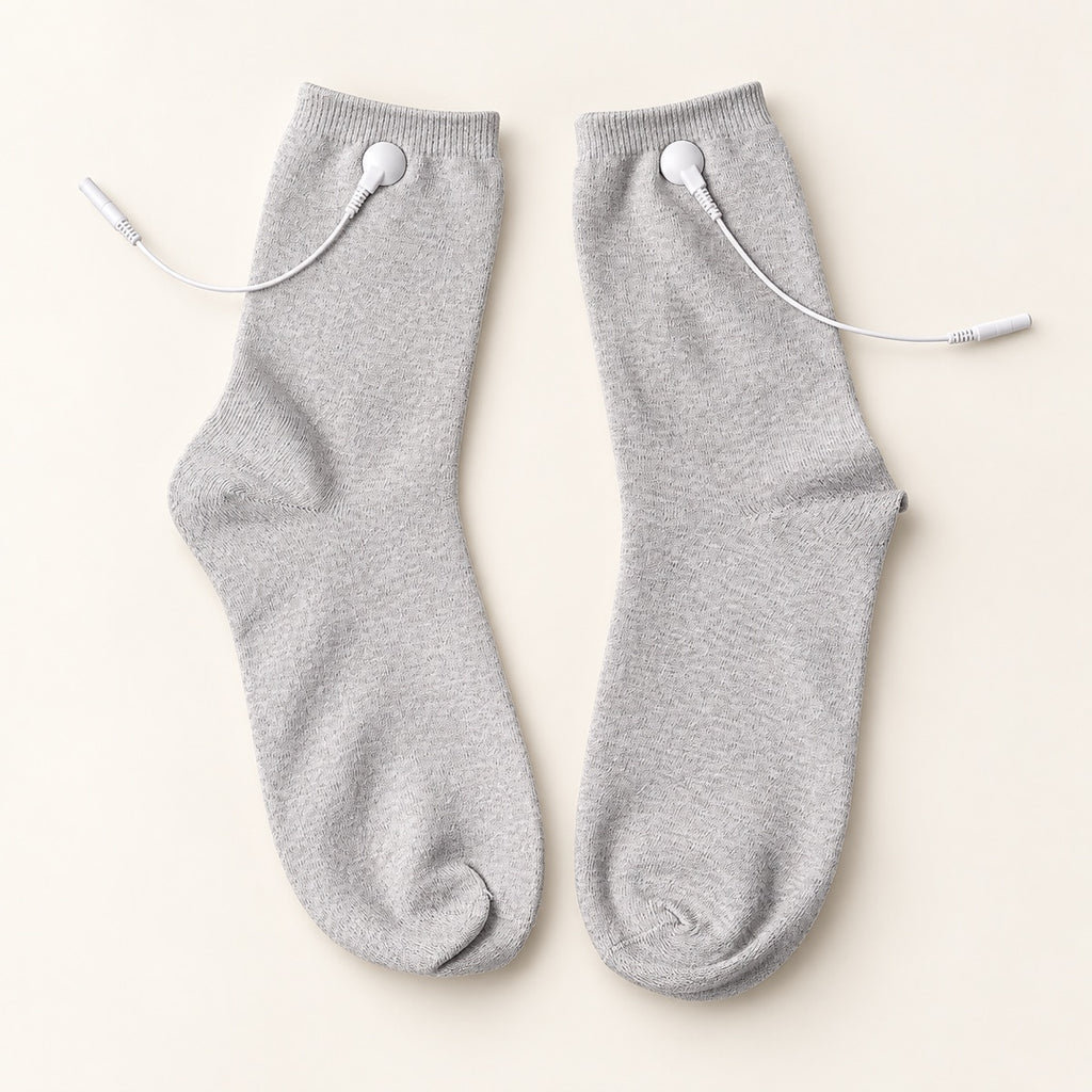 TENS therapy socks — a pair laid flat showing silver fibre fabric and snap connectors